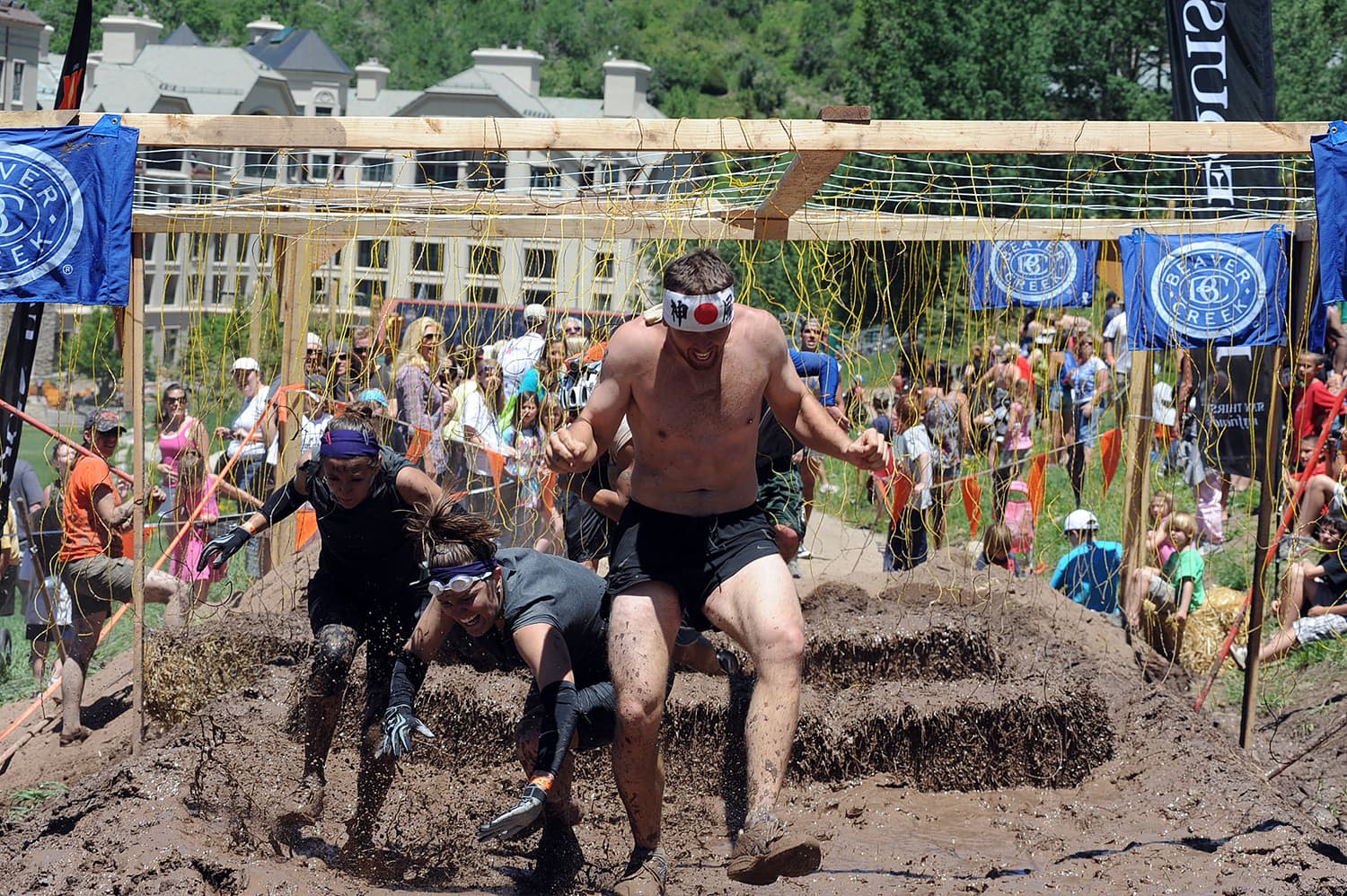 People race through the mud during a Tough Mudder event in Beaver Creek