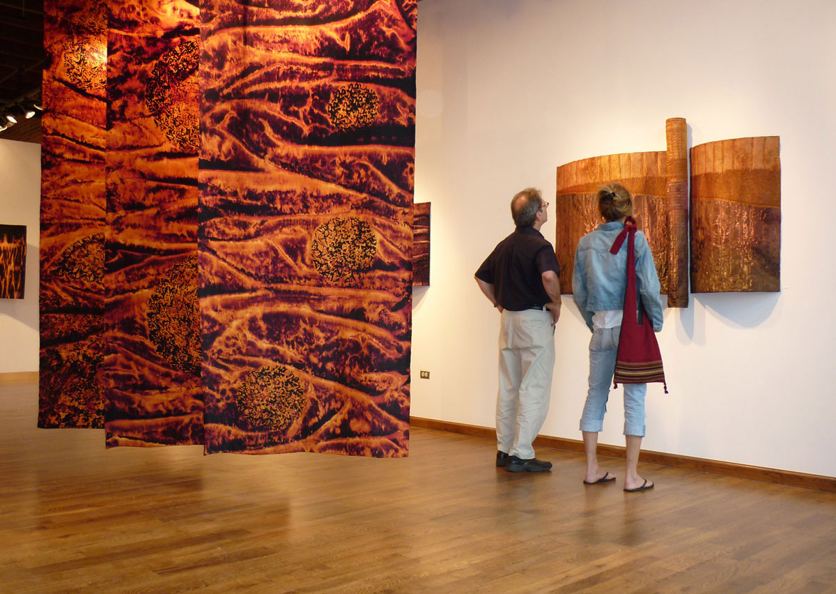 Two patrons looking at artwork as part of RINO Art District art walk