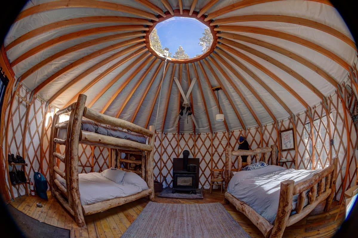 Beds and a heater inside a cozy yurt
