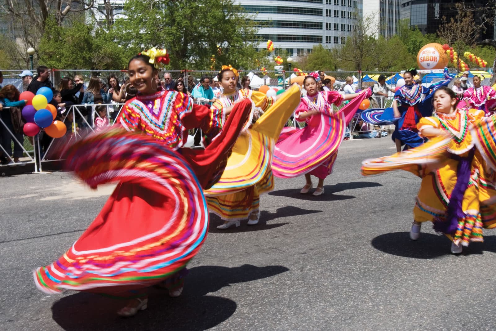 Dancers in colorful costumes perform in the streets of the city
