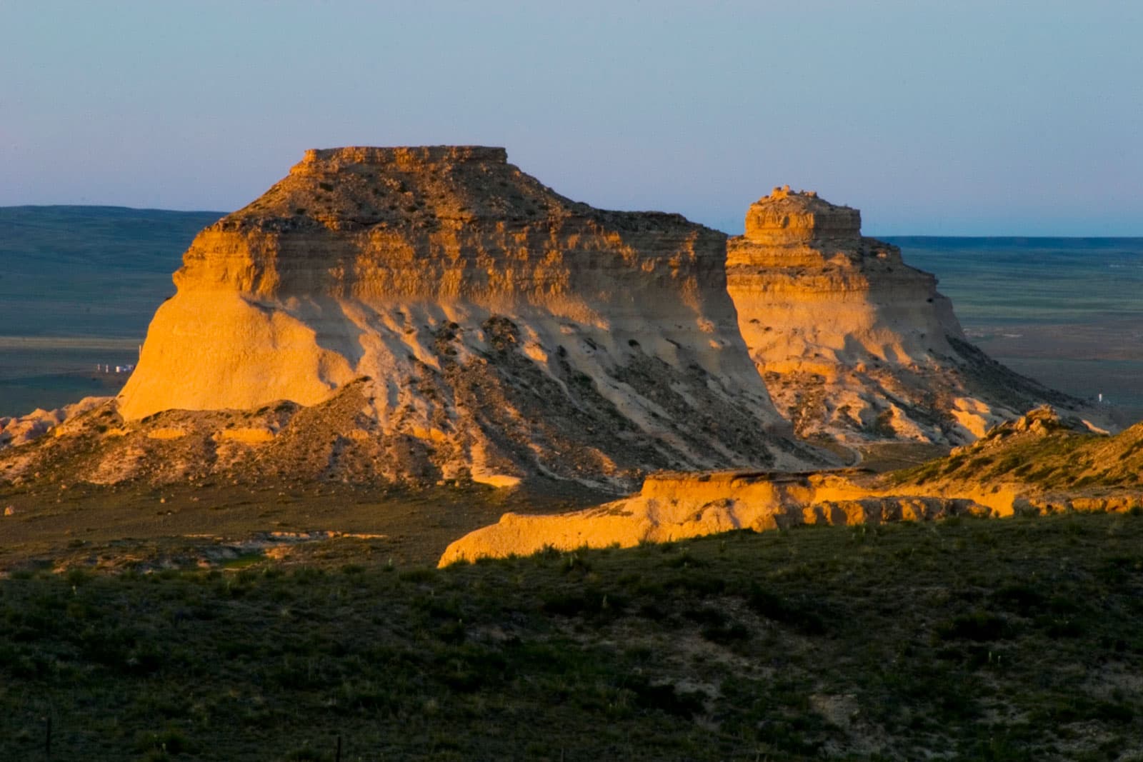 Sunlight reflects on a towering rock formation