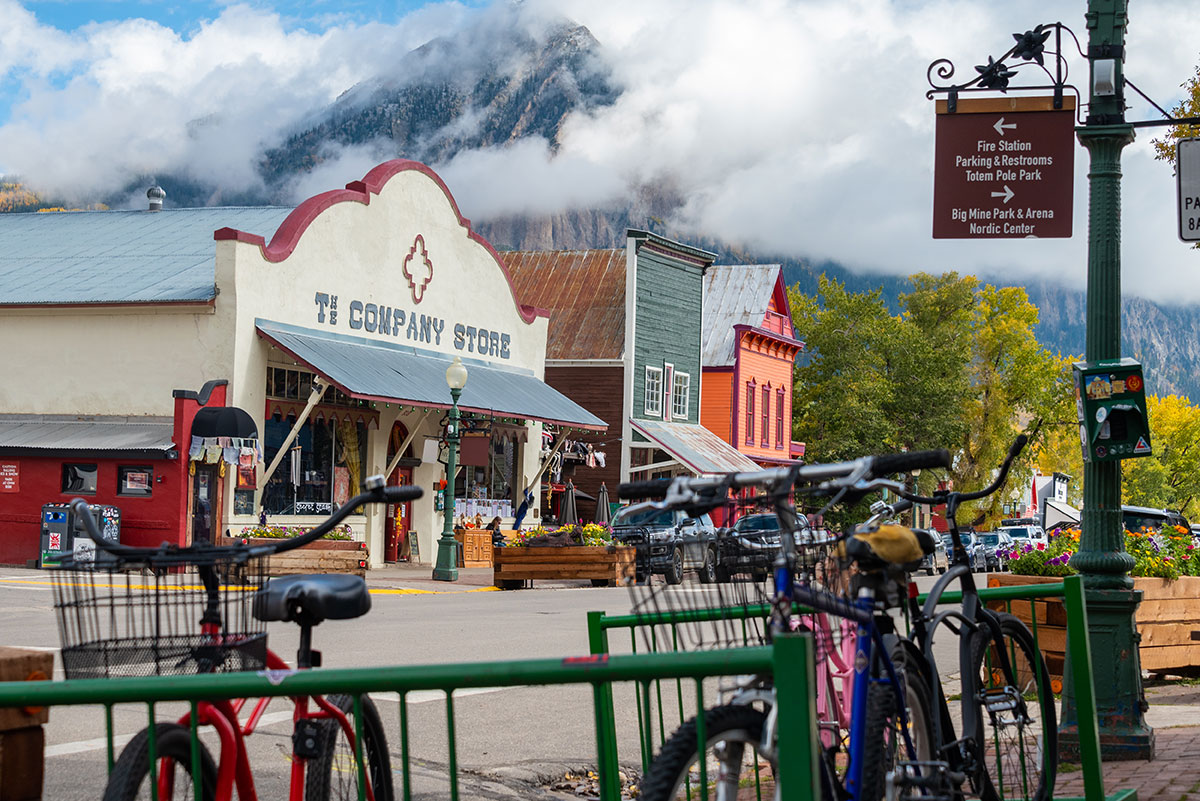 Street scene of colorful buildings and bicycles with a mountain looming in the background