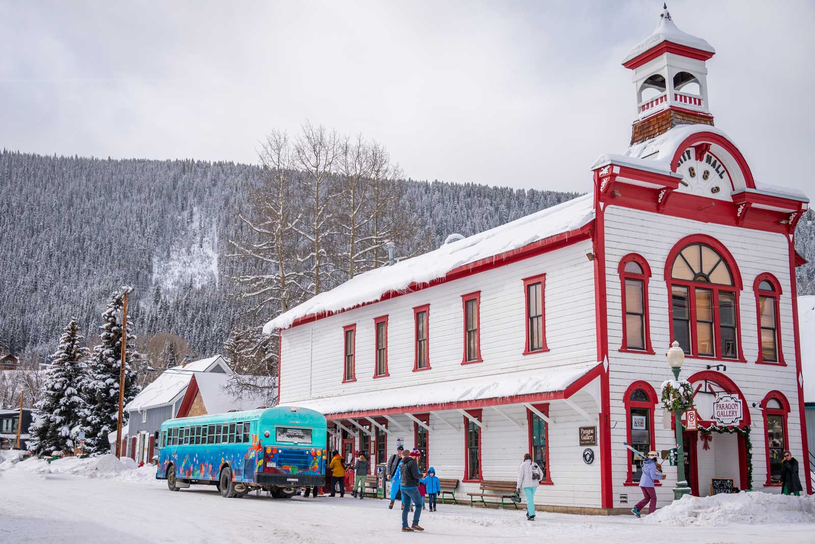 Amid a snowy scene, a red-and-white wooden building in downtown Crested Butte
