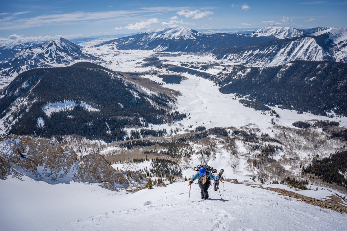 A person uphill skis in the mountains of Gunnison County in Colorado