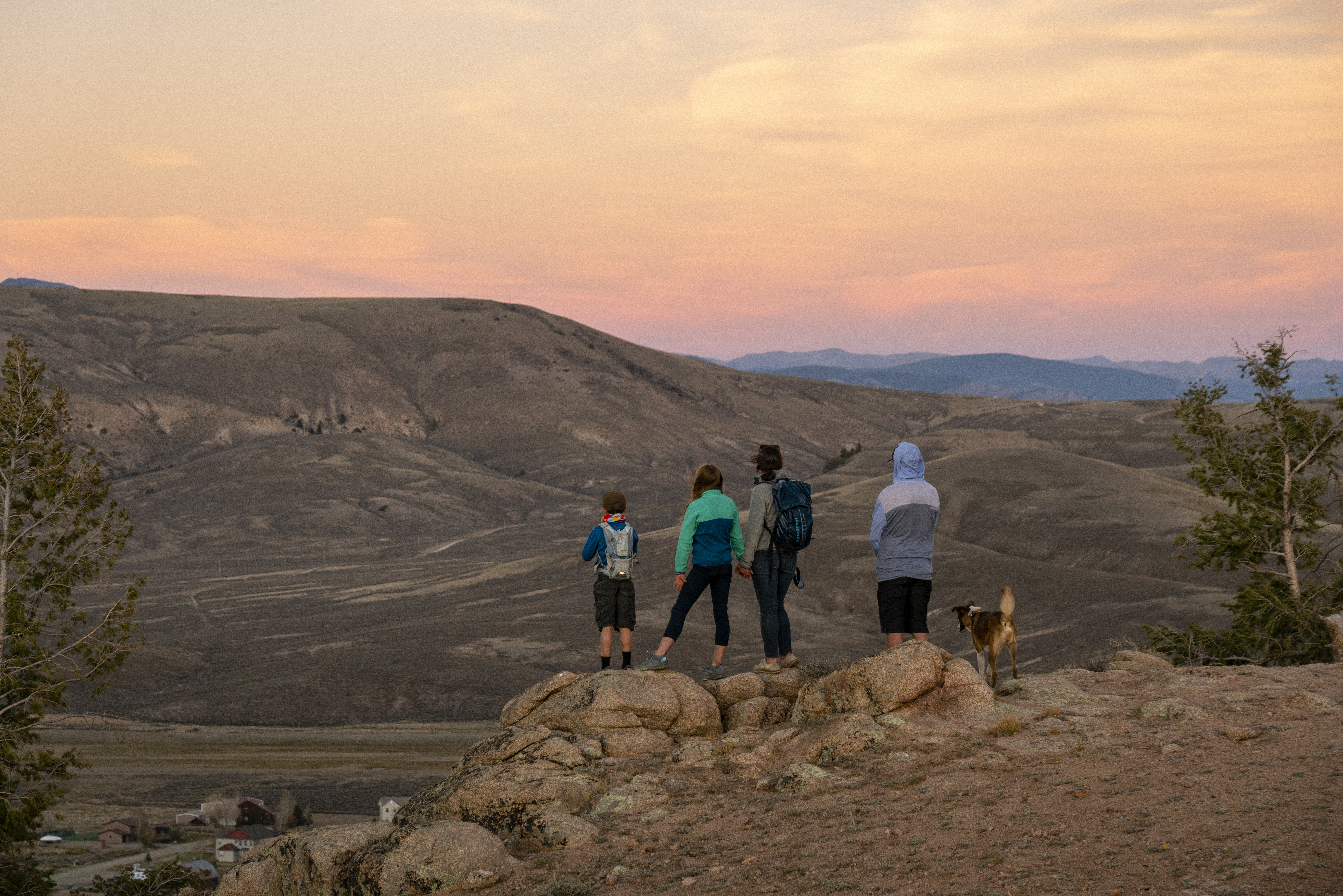 People stand on an overlook at Hartman Rocks watching the sunset in Gunnison Colorado.