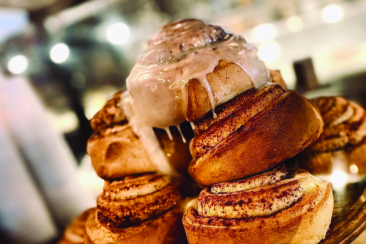 Glazed cinnamon rolls stacked at Muddy Buck Coffee House