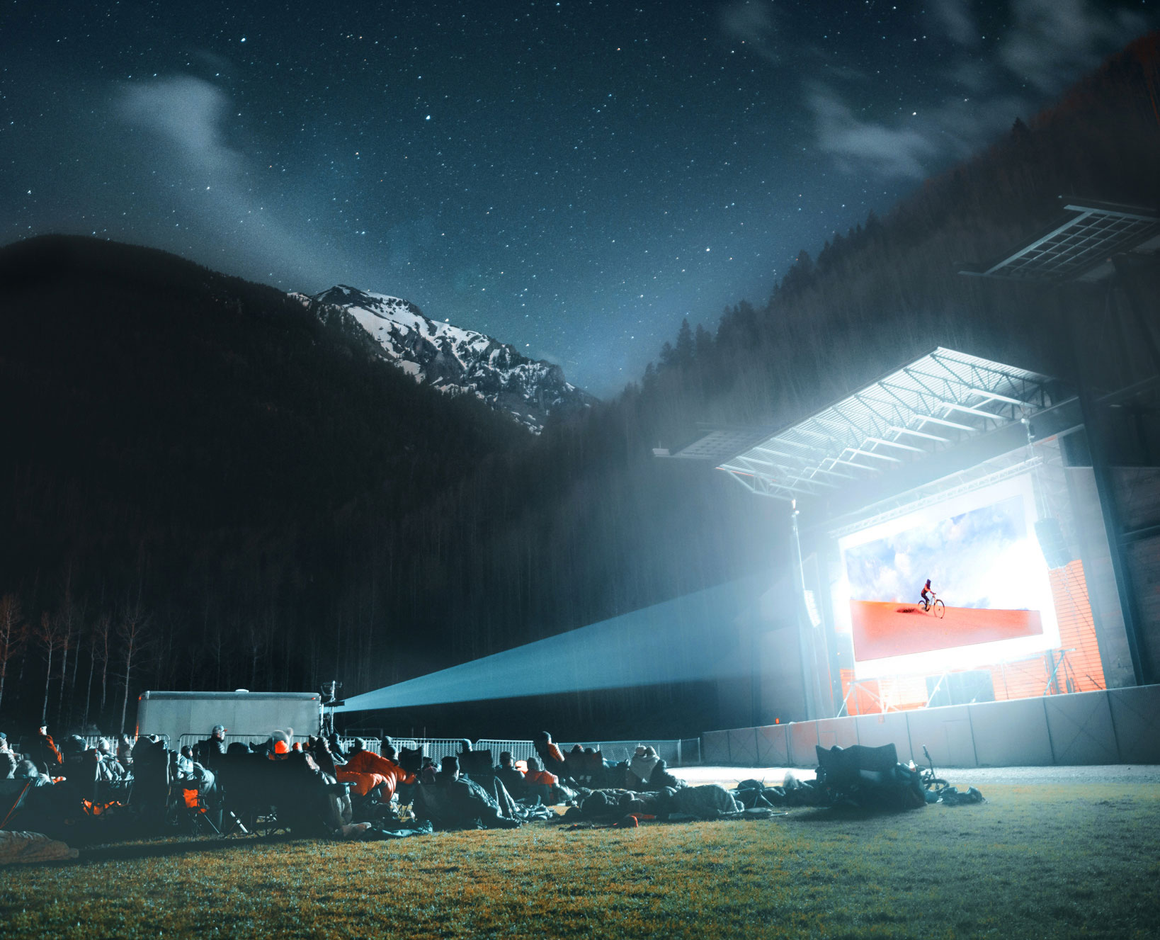 A film shows on an outdoor screen at night in Telluride