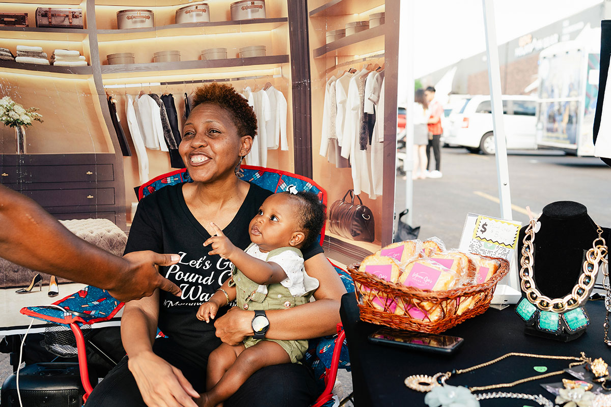 A woman and a baby at a marketplace stall in Aurora.