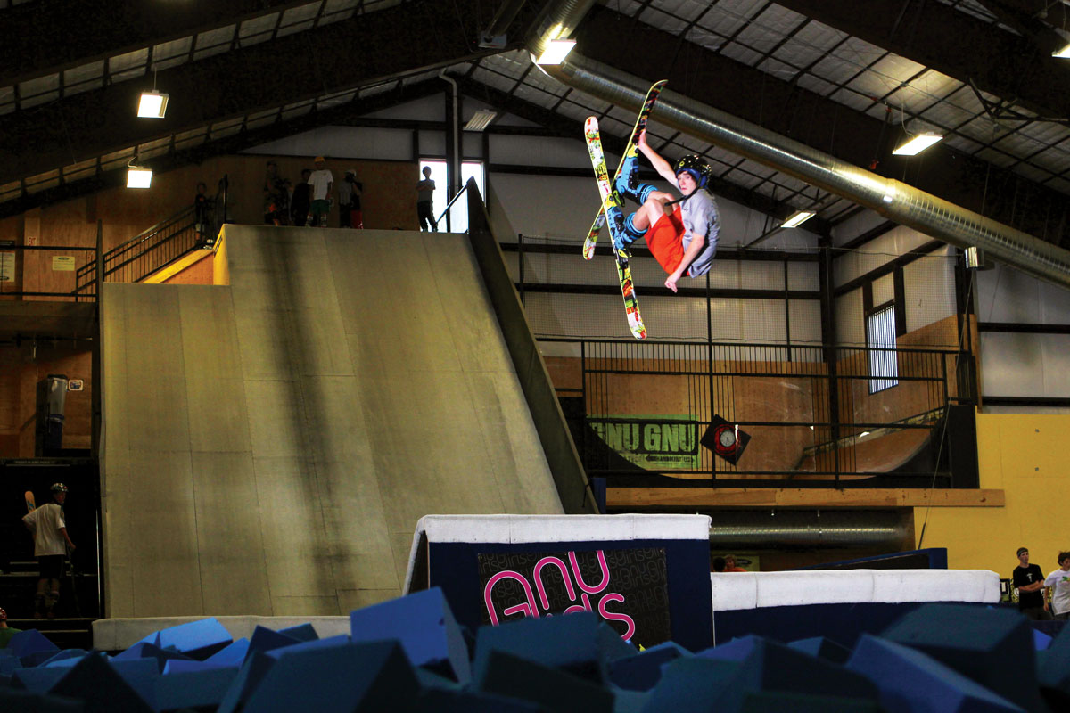 A person in a helmet does a trick in the air at Woodward Copper at Copper Mountain